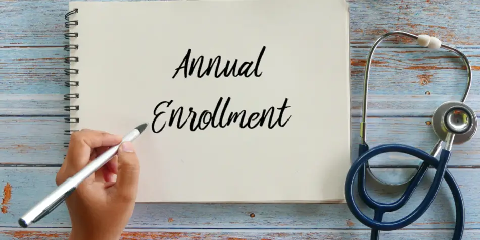 Notebook with "Annual Enrollment" and stethoscope.